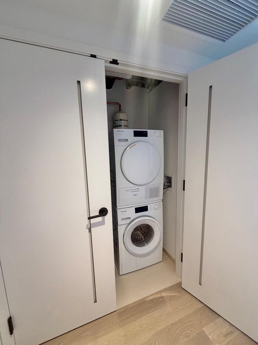 A white washing machine and dryer in a small laundry room.